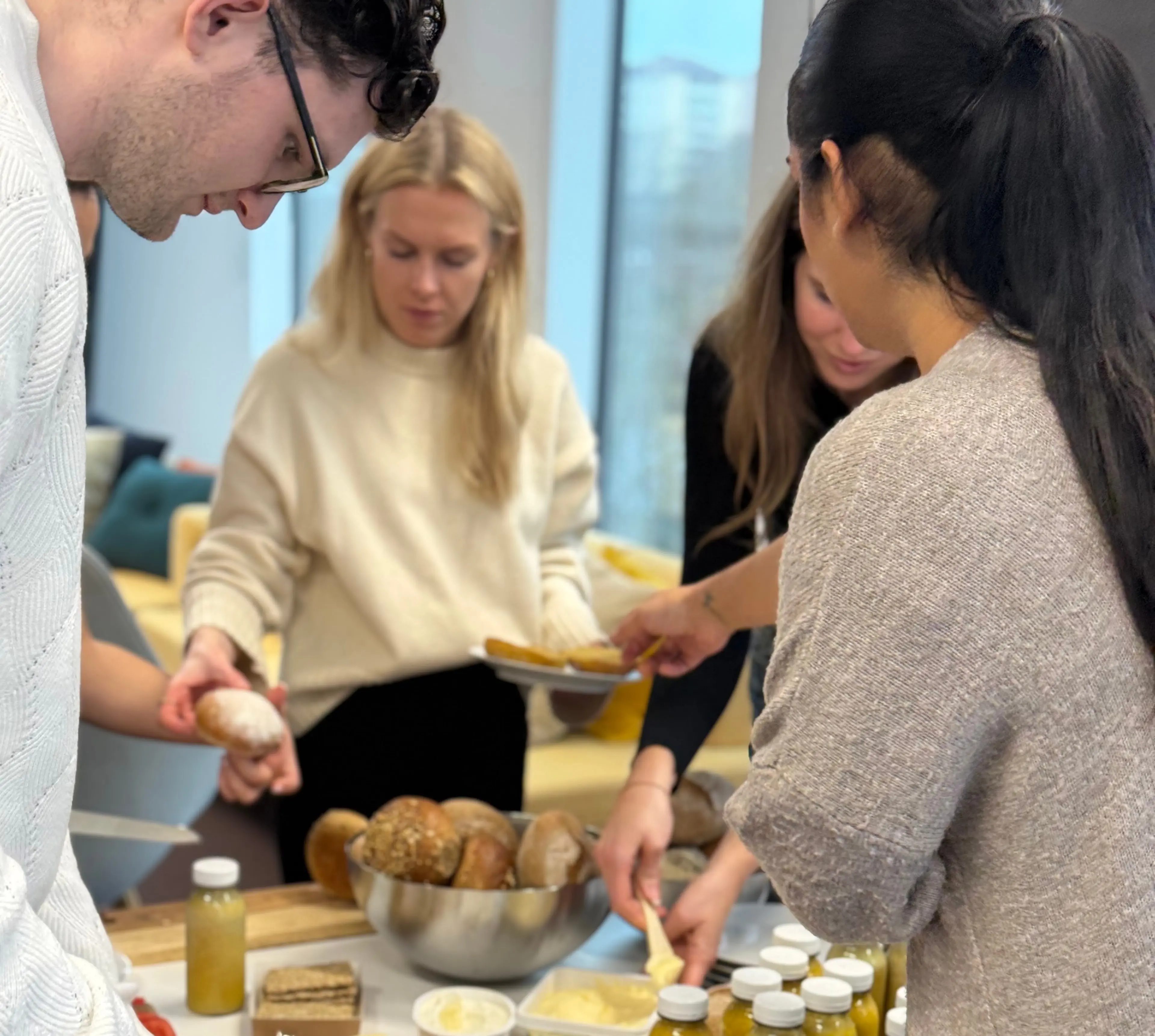 Colleagues having breakfast together at the office
