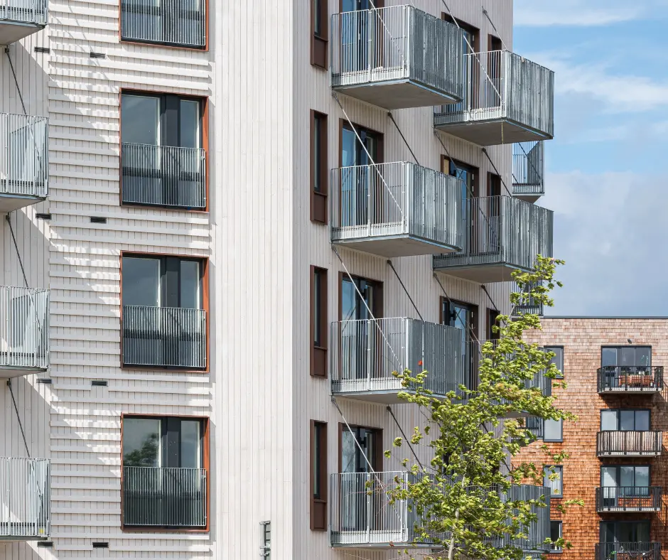 Apartment building with a white timber facade and balconies